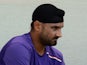 Indian cricketer Harbhajan Singh puts on his pads as he prepares to bat during a training session at The Sardar Patel Stadium at Motera in Ahmedabad on November 14, 2012
