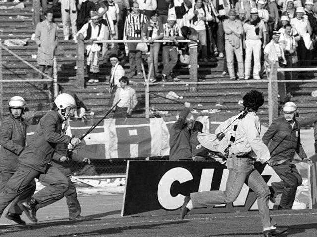 Belgium policemen run after Italian fans in Heysel stadium in Brussels on May 29, 1985