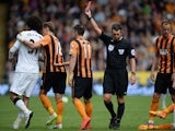 Referee Lee Probert shows a red card to Manchester United's Belgian midfielder Marouane Fellaini after a foul on Hull City's Irish defender Paul McShane during the English Premier League football match between Hull City and Manchester United at the KC Sta