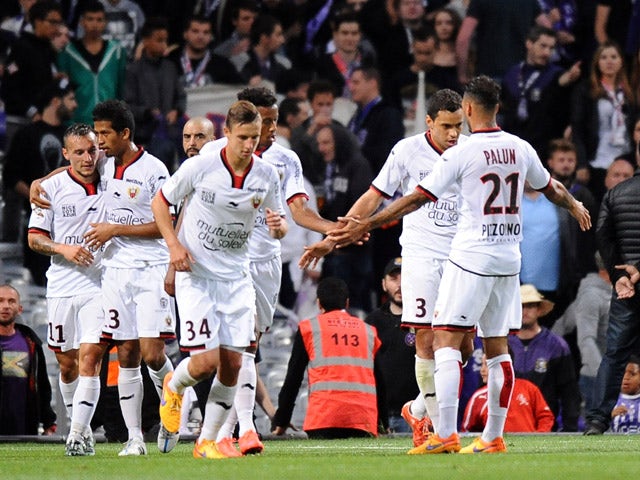 Nice's Eric Bautheac is congratulated by teammates after scoring a goal during the French L1 football match Toulouse vs Guigamp on December 20, 2015