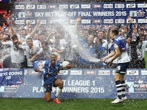 Preston North End players take a spray to the face after winning promotion to the Championship on May 24, 2015