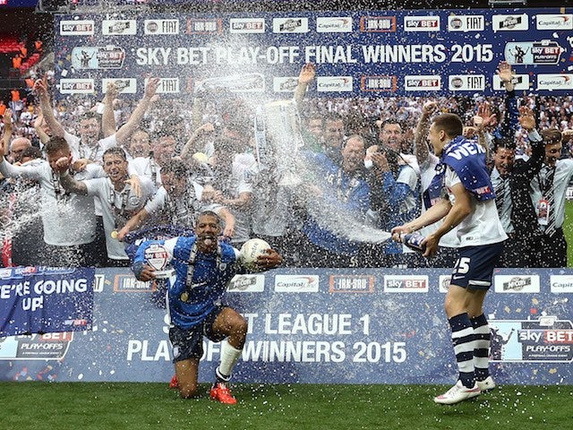 Preston North End players take a spray to the face after winning promotion to the Championship on May 24, 2015