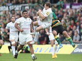 Alex Goode of Saracens catches the ball as George Pisi challenges during the Aviva Premiership play off semi final match between Northampton Saints and Saracens at Franklin's Gardens on May 23, 2015