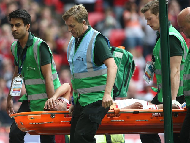 Nathan Thompson of Swindon Town is stretchered off during the League One play-off final between Preston North End and Swindon Town at Wembley Stadium on May 24, 2015