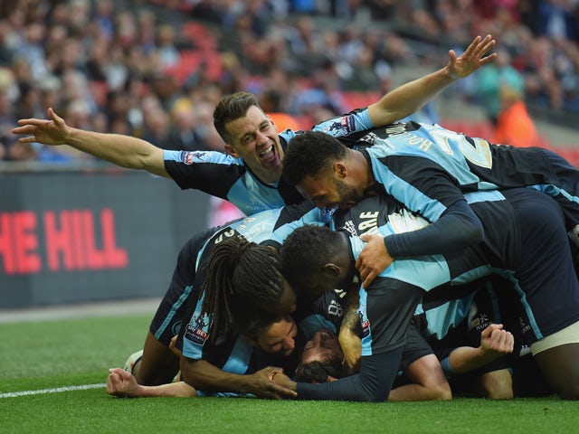 Ben Coker of Wycombe celebrates scoring a free kick to make it 1-0 with team mates during the Sky Bet League Two Playoff Final match between Southend United and Wycombe Wanderers at Wembley Stadium on May 23, 2015