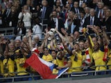 Arsenal lift the FA Cup trophy at Wembley after beating Aston Villa 4-0 on May 30, 2015
