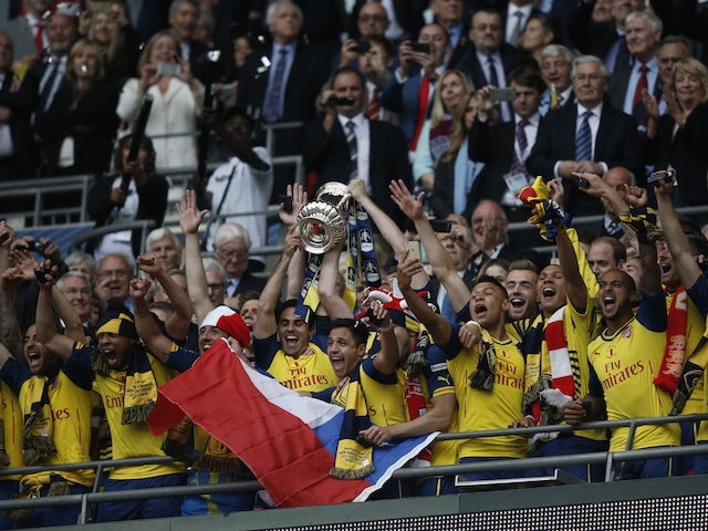 Arsenal lift the FA Cup trophy at Wembley after beating Aston Villa 4-0 on May 30, 2015