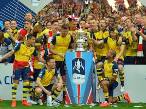 The Arsenal team pose with the trophy after winning the FA Cup final football match between Aston Villa and Arsenal at Wembley stadium in London on May 30, 2015