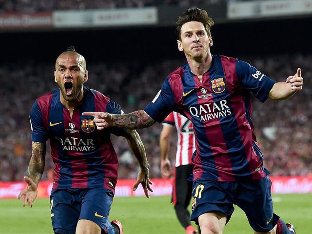 Barcelona's Argentinian forward Lionel Messi celebrates his goal past Barcelona's Brazilian defender Dani Alves during the Spanish Copa del Rey (King's Cup) final football match Athletic Club Bilbao vs FC Barcelona at the Camp Nou stadium in Barcelona on 
