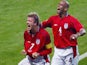 English midfielder David Beckham (L) and his teammate defender Trevor Sinclair jubilate after David Beckham scored a goal during the Group F first round match Argentina/England of the 2002 FIFA World Cup in Korea and Japan, 07 June 2002