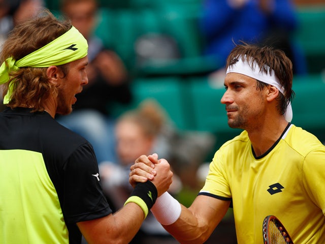 Lukas Lacko of Slovakia shakes hands with David Ferrer of Spain after Men's Singles match against on day three of the 2015 French Open at Roland Garros on May 26, 2015