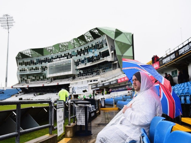 An England fan waits patiently in the rain on day one of the Second Test with New Zealand on May 29, 2015