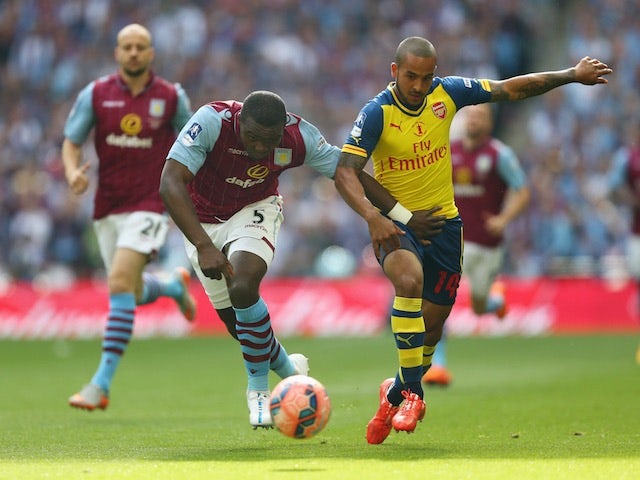 Aston Villa defender Jores Okore and Theo Walcott of Arsenal contest for the ball during the FA Cup final at Wembley on May 30, 2015