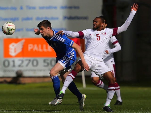 Qatar's Majdi Siddiq (R) vies for the ball with Northern Ireland`s Patrick McNair during the international friendly football match between Qatar and Northern Ireland at the Alexandra Stadium in Crewe on May 31, 2015