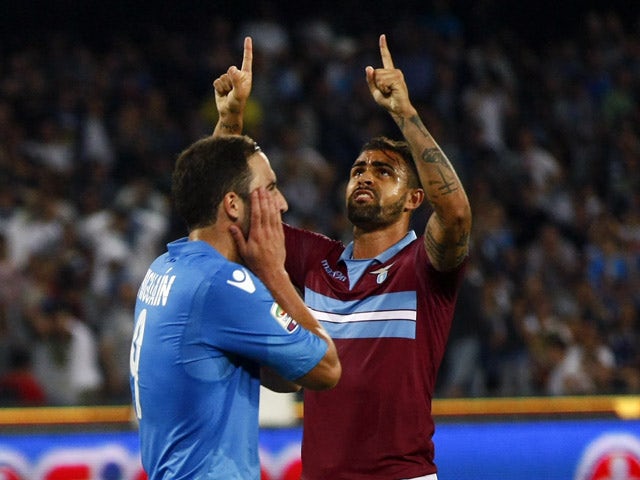 Napoli's French Argentinan forward Gonzalo Higuain reacts after missing a penalty as Lazio's Brazilian defender Mauricio gestures during the Italian Serie A football match SSC Napoli vs SS Lazio on May 31, 2015