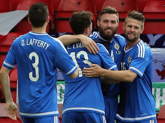 Northern Ireland's Stuart Dallas (2R) is congratulated after scoring during the international friendly football match between Qatar and Northern Ireland at the Alexandra Stadium in Crewe on May 31, 2015