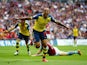 Theo Walcott wheels away in celebration after scoring the opening goal of the FA Cup final at Wembley between Arsenal and Aston Villa on May 30, 2015