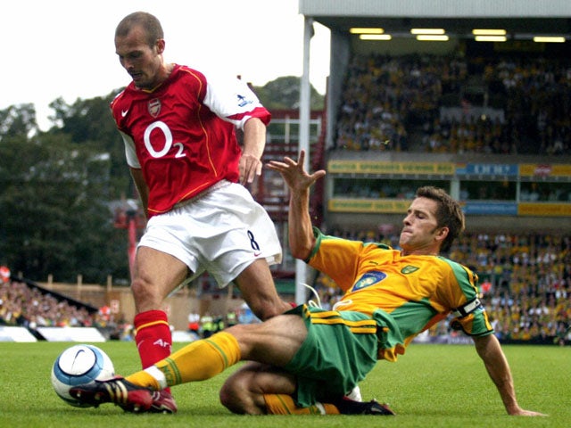 Arsenal's Freddy Ljungberg (L) is challenged by Norwich's Adam Drury for the ball during their Premiership match 28th August, 2004