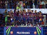 Neymar of Barcelona lifts the trophy as he celebrates victory with team mates after the UEFA Champions League Final between Juventus and FC Barcelona at Olympiastadion on June 6, 2015