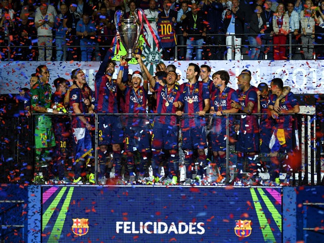 Neymar of Barcelona lifts the trophy as he celebrates victory with team mates after the UEFA Champions League Final between Juventus and FC Barcelona at Olympiastadion on June 6, 2015