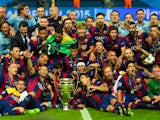 The Barcelona team celebrate victory with the trophy after the UEFA Champions League Final between Juventus and FC Barcelona at Olympiastadion on June 6, 2015