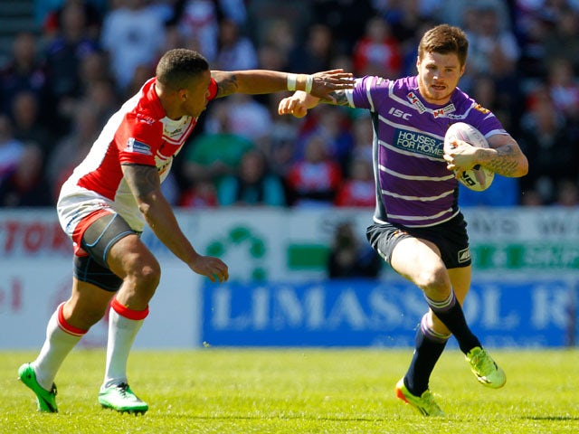 Darrell Goulding of Wigan in action with Jordan Turner of St Helens during the Super League match between St Helens and Wigan Warriors at Langtree Park on April 18, 2014
