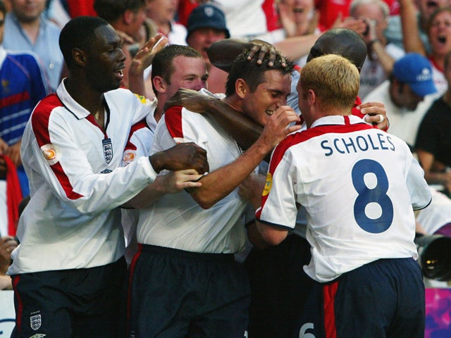 Frank Lampard of England is congratulated by his team-mates after he scores their first goal during the France v England Group B match in the 2004 UEFA European Football Championships at the Estadio da Luz on 13 June, 2004