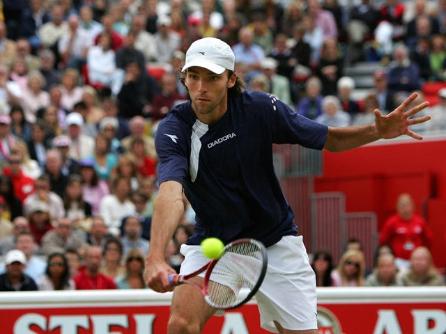 Croatian Ivo Karlovic comes to the net to play a volley during the final match against US Andy Roddick during the final of the Queen's Club tournament 12 June 2005