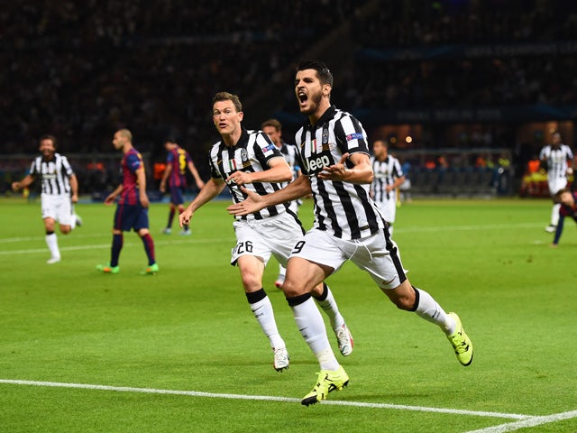Alvaro Morata of Juventus celebrates scoring his team's first goal with Stephan Lichtsteiner during the UEFA Champions League Final between Juventus and FC Barcelona at Olympiastadion on June 6, 2015
