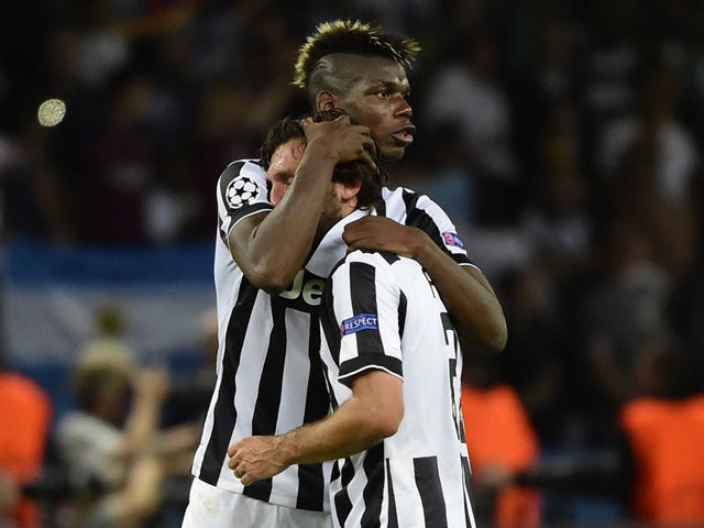 Juventus' midfielder Andrea Pirlo and Juventus' French midfielder Paul Pogba reacts after the UEFA Champions League Final football match between Juventus and FC Barcelona at the Olympic Stadium in Berlin on June 6, 2015