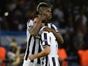 Juventus' midfielder Andrea Pirlo and Juventus' French midfielder Paul Pogba reacts after the UEFA Champions League Final football match between Juventus and FC Barcelona at the Olympic Stadium in Berlin on June 6, 2015