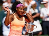 Serena Williams celebrates with the trophy after winning the 2015 French Open women's singles at Roland Garros on June 6, 2015