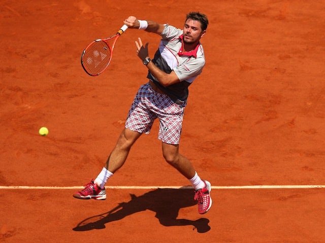 Stanislas Wawrinka plays an overhead shot during the French Open semi-final against Jo-Wilfried Tsonga at Roland Garros on June 5, 2015