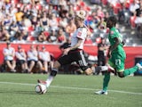 Germany's Anja Mittag shoots to score despite Ivory Coast's Sophie Aguie (R) during a Group B match at the 2015 FIFA Women's World Cup at Landsdowne Stadium in Ottawa on June 7, 2015
