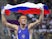 Russias Artem Surkov holds aloft his national flag following his bout against Armenias Migran Arutyunyan in the mens Greco-Roman 66kg wrestling Gold medal event of the 2015 European Games in Baku on June 14, 2015