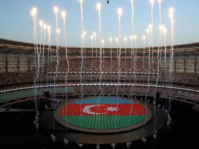 Performers depict the national flag of Azerbaijan during the Opening Ceremony for the Baku 2015 European Games at the National Stadium on June 12, 2015