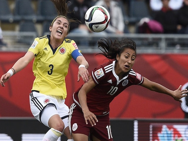 Colombia's midfielder Catalina Usme (L) vies with Mexico's defender Christina Murillo during a Group F match at the 2015 FIFA Women's World Cup between Colombia and Mexico at Moncton Stadium in Moncton, New Brunswick on June 9, 2015 