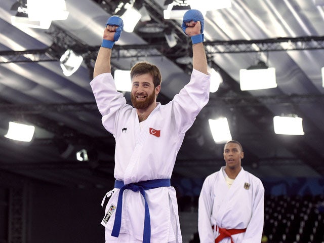 Turkey's Enes Erkan (front) reacts after winning the gold medal after competing against Germany's Jonathan Horne (background) in the Men's Karate Kumite +84kg, during the 2015 European Games in Baku on June 14, 2015