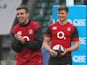 George Ford (L) looks on with Owen Farrell during the England captain's run at Twickenham Stadium on November 21, 2014