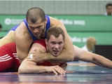 Russia's Islam Magomedov (top) wrestles with Germany's Oliver Hassler during their mens greco-roman 98kg wrestling qualification event of the 2015 European Games in Baku on June 13, 2015