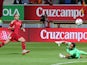 Spain's forward Paco Alcacer shoots against Costa Rica's goalkeeper Keilor Navas to score a goal during the friendly football match Spain vs Costa Rica at the Reino de Leon stadium in Leon on June 11, 2015