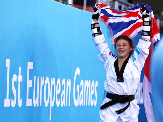 Charlie Maddock celebrates with the Union Jack after winning taekwondo gold for Team GB at the European Games on June 16, 2015