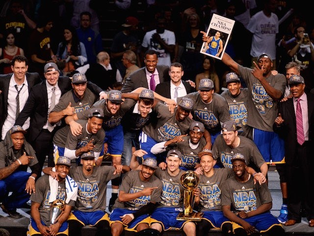 The Golden State Warriors celebrate with the Larry O'Brien trophy after winning the NBA title on June 16, 2015