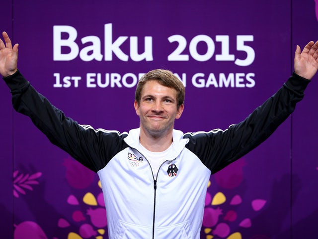 Gold medalist Henri Junghaenel of Germany celebrates priorto receiving the medal won in the Men's 50m Rifle Prone final during day six of the Baku 2015 European Games at the Baku Shooting Centre on June 18, 2015