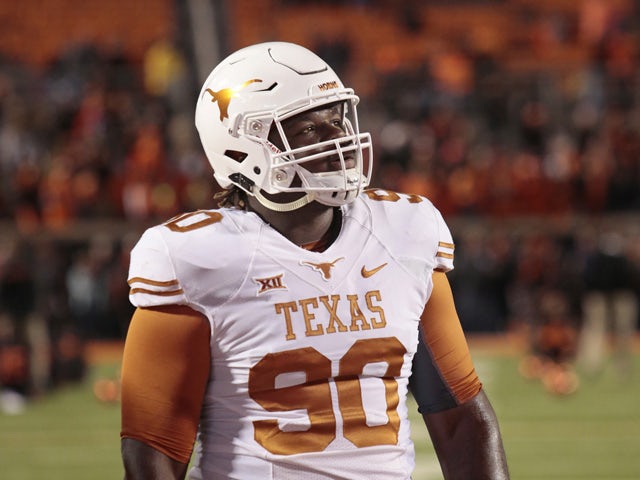 Defensive tackle Malcom Brown #90 of the Texas Longhorns looks at the video board before the game against the Oklahoma State Cowboys November 15, 2014
