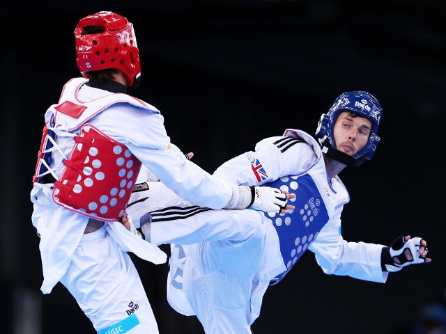 Martin Stamper of Team GB goes for a kick against Czech Republic's Filip Grgic during their preliminary fight at the 2015 European Games in Baku