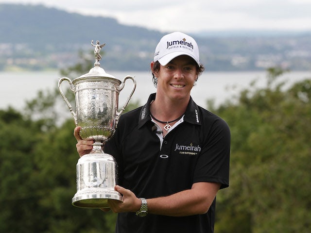 US Open winning golfer Rory McIlroy poses with his trophy on a green at Holywood Golf Club on June 22, 2011