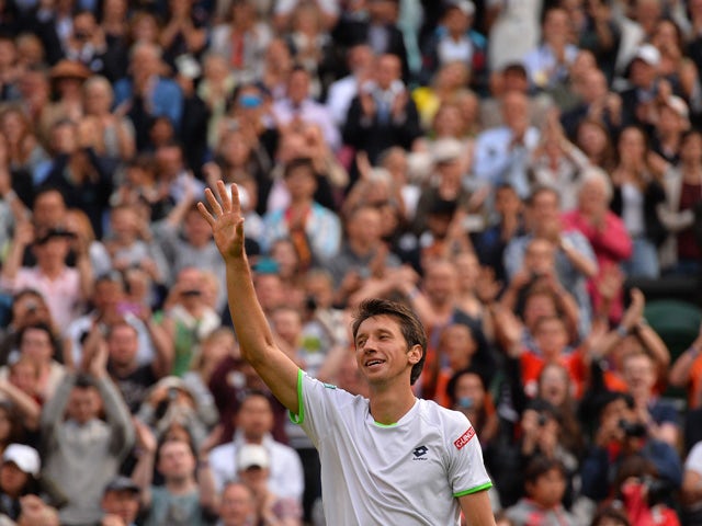 Ukraine's Sergiy Stakhovsky celebrates beating Switzerland's Roger Federer in their second round men's singles match on day three of the 2013 Wimbledon Championships tennis tournament at the All England Club in Wimbledon, southwest London, on June 26, 201
