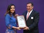 Konul Nurullayeva (L) the Chef de Mission of Azerbaijan is presented with a plaque by Spyros Capralos (R) the Coordination Chairman of the European Games during the arrival of the torch for the athletes welcome ceremony in the athletes village ahead of th