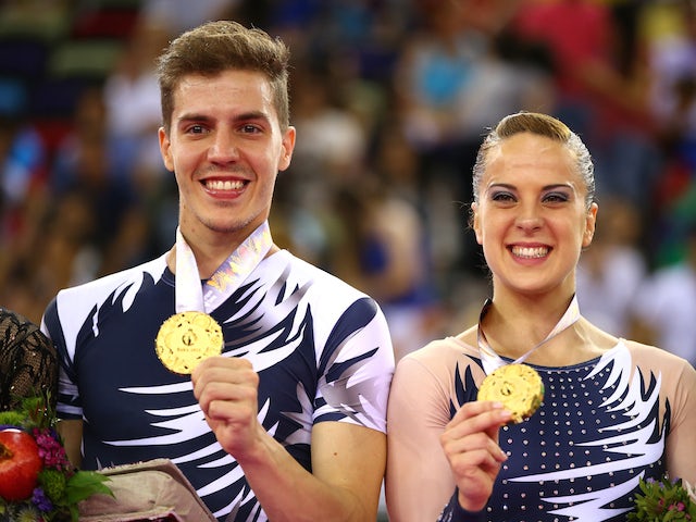 Gold medalists Vicente Lli Lloris and Sara Moreno Lopez of Spain celebrate on the podium during the medal ceremony for the Aerobic Gymnastics Mixed Pairs final on day nine of the Baku 2015 European Games at the National Gymnastics Arena on June 21, 2015